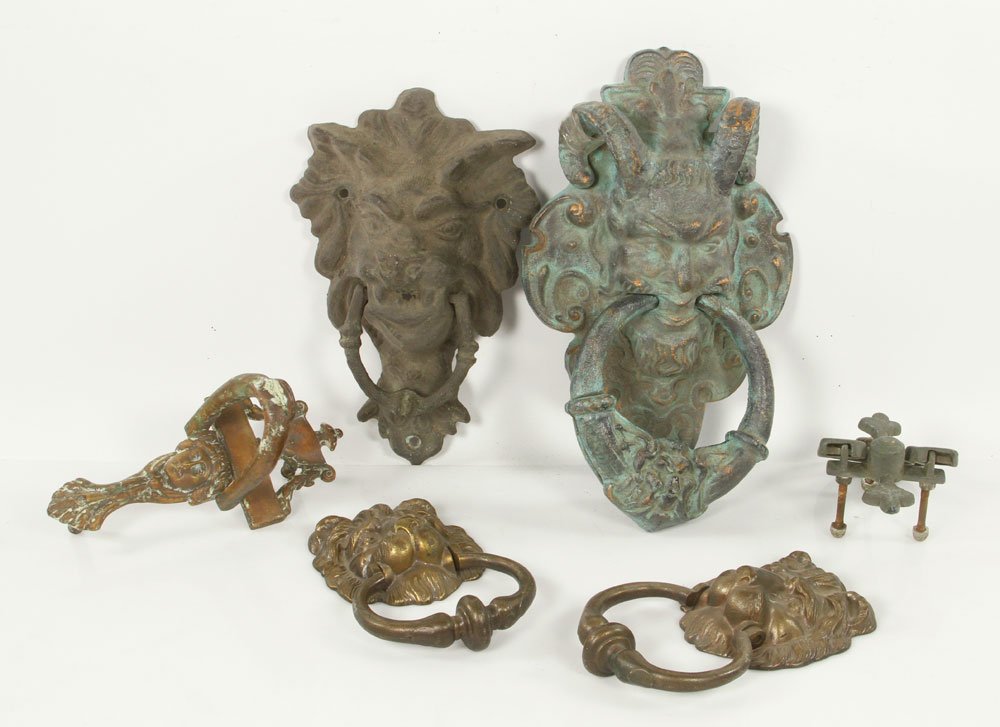 Lot of Victorian Door Knockers: Lot of six Victorian door knockers, brass and iron, to include: figural Pan knocker, two lion-head knockers, one cruciform knocker, one classical figure head knocker and one mythical beast head knocke