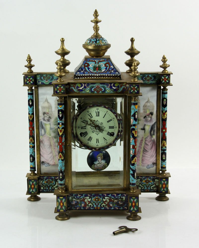 French Champleve Enameled Brass Clock: French champleve brass clock, with enameled panels showing ladies standing before tower, includes weights and pendulum, 19" h x 13" w x 6" d.