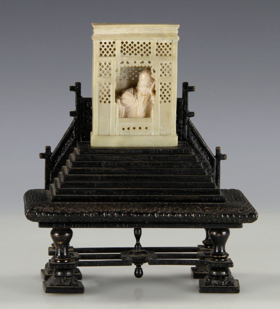 19th C. Chinese Soapstone Figure: Chinese carved soapstone figure, 19th century, showing figure sitting in window, on wooden stand, 8" h x 7" w x 4" d.