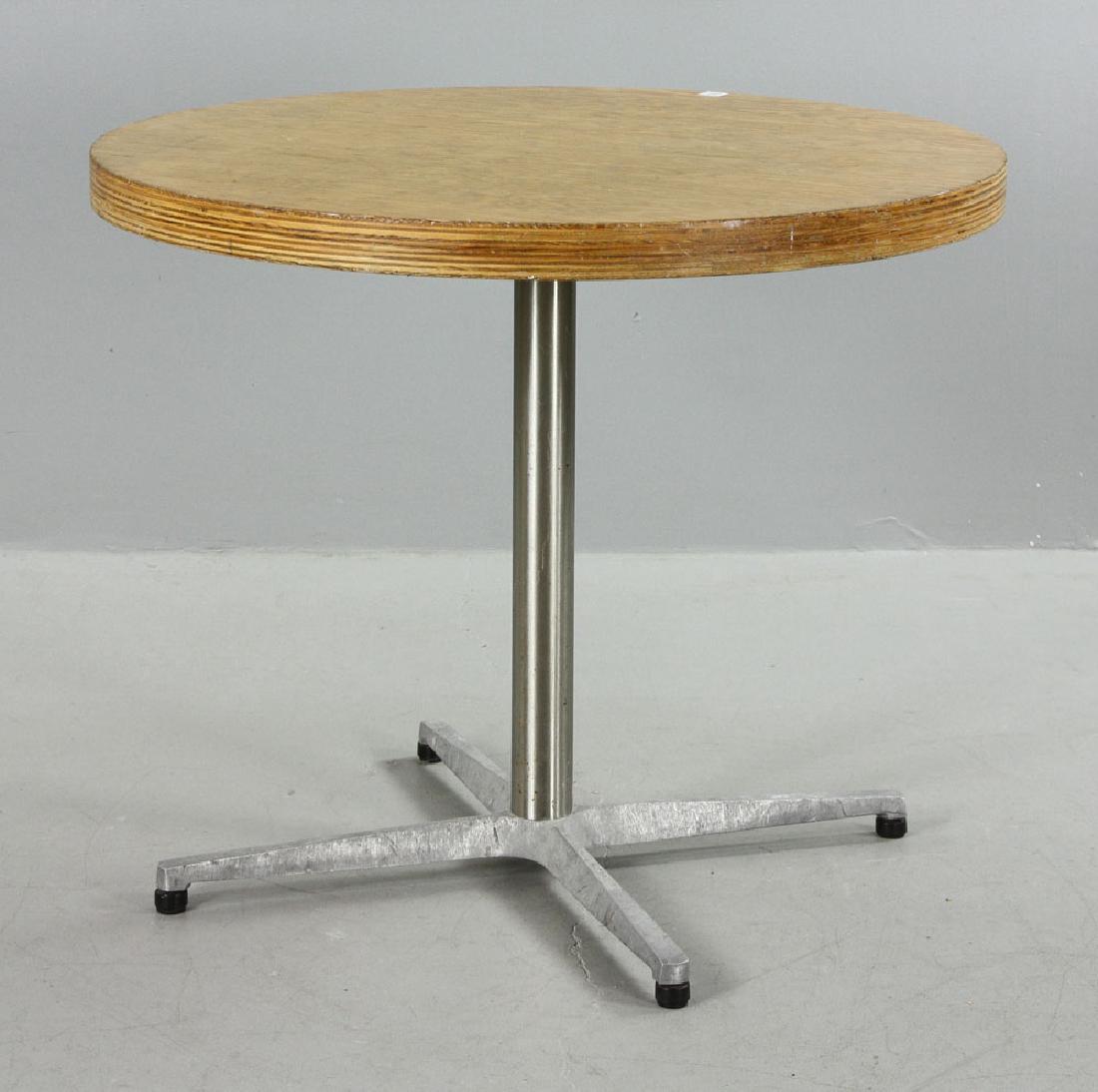 Gehry Round Table: Frank Gehry round table, plywood top with stainless pedestal and four-footed aluminum feet and legs, having stamps and labels for MIT and Polybois Millworks, Quebec, Canada 2004, 30" high x 36" diamet