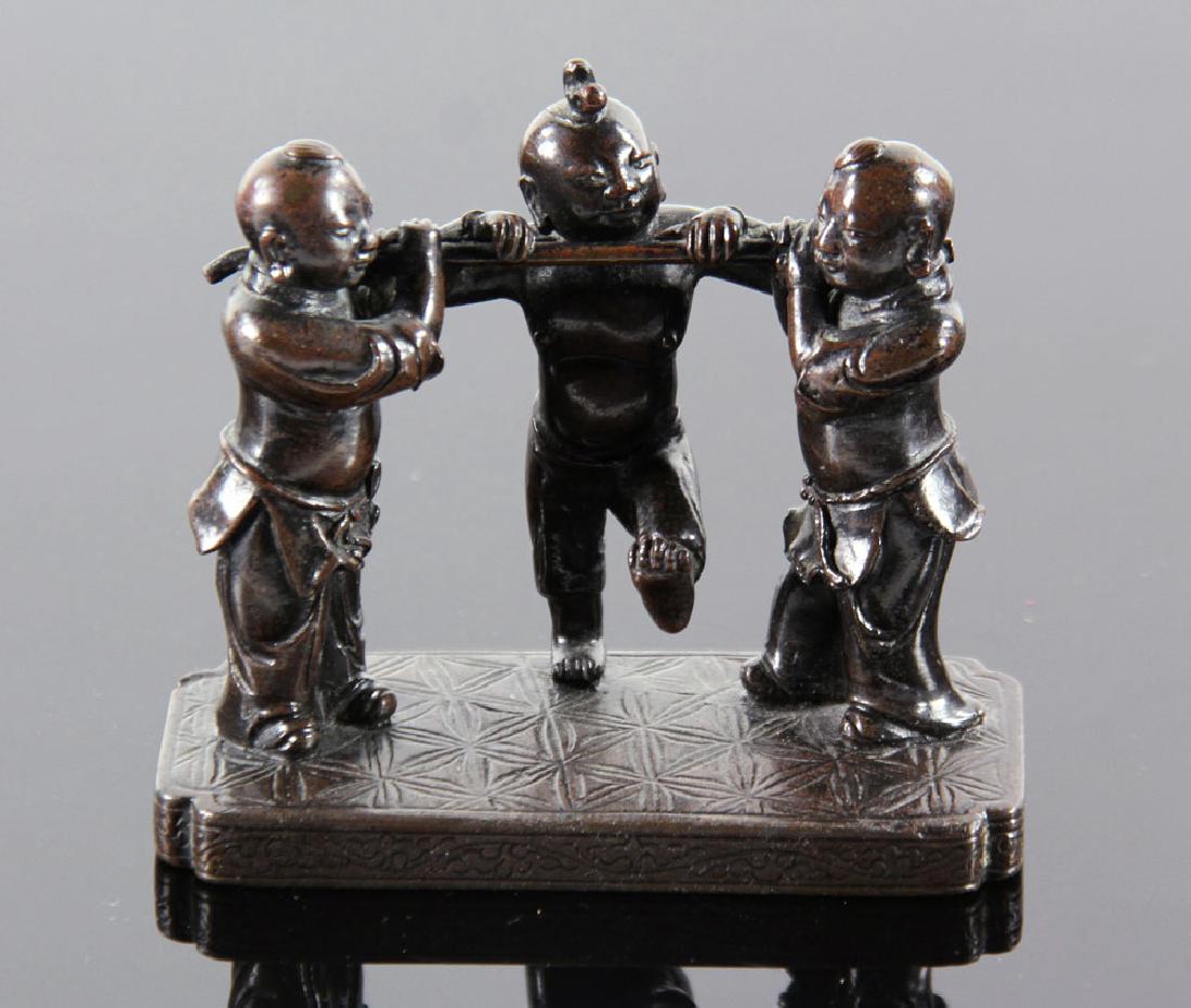 Chinese Ming Dynasty Bronze Scroll Weight: Chinese bronze scroll weight, Ming Dynasty, in the form of three figures, 3 1/2" h x 3 3/4" w. Provenance: From a Santa Barbara, California estate.
