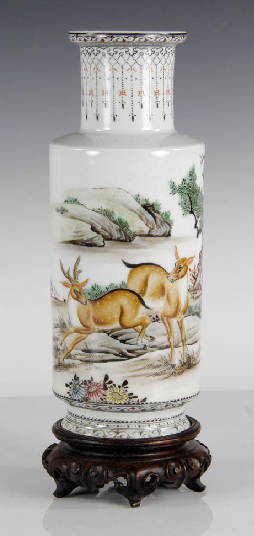 Chinese Famille Rose Porcelain Vase: Chinese porcelain famille-rose vase, 20th century, decorated with two running deer in wooded landscape, with Chinese calligraphy and red Wang Yihou mark on base, on original wooden stand, 9 3/4" h.