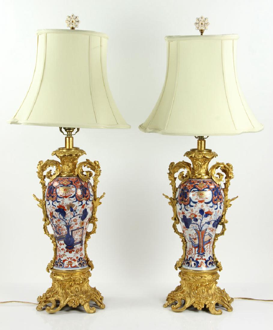 Pr. Japanese Imari Vases: Pair of Japanese Imari vases, 19th century, converted into lamps, with ormolu mounts, including shades and finials, 33" h x 20" w x 14 1/2" d. Provenance: From the lifetime collection of Cheryl Burke 