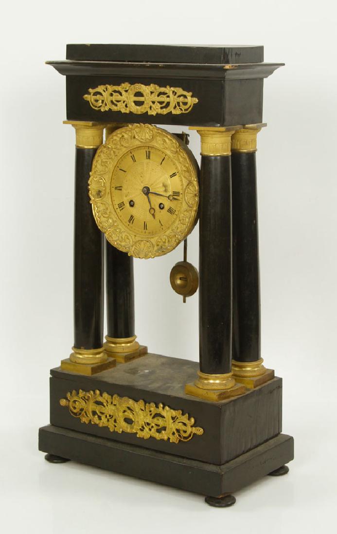 19th C. French Empire Clock: French Empire clock, 19th century, bronze and black ebonized wood, 18" h x 9 1/2" w x 5 1/2" d; broken back, without pendulum and key. Provenance: From a Massachusetts collection.