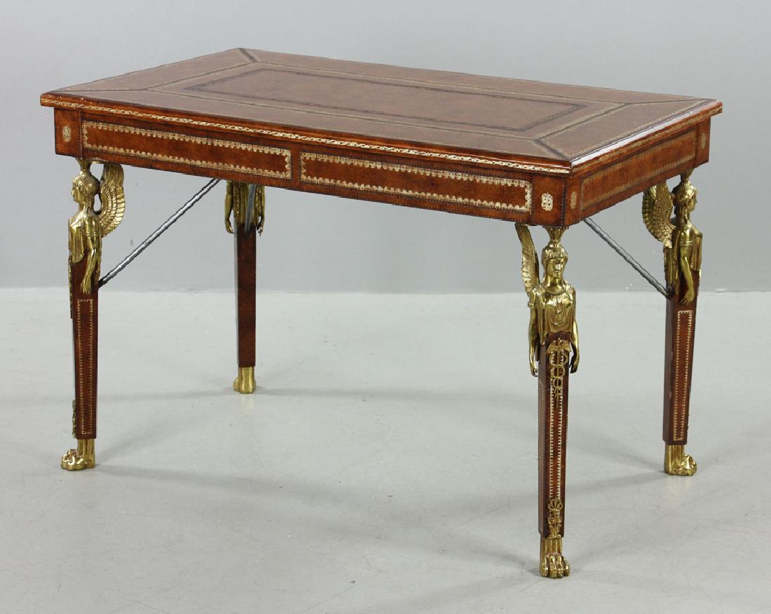 Maitland Smith French Desk: Maitland Smith French desk, with two drawers and ormolu mounts in the form of winged classical figures, on lion's paw feet, with gilt accents, 29 1/2" h x 43 1/2" w x 26" d. Provenance: From the lifet