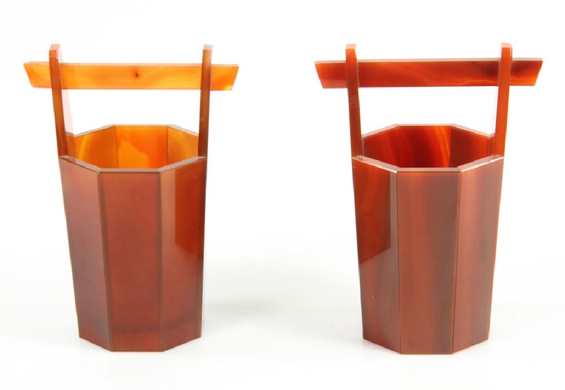Pr. Chinese Carnelian Buckets: Pair of Chinese carnelian buckets, circa 1920, 6" h x 4 1/4" w. Provenance: From the personal collection of Cheryl Burke, of Sarasota, Florida.