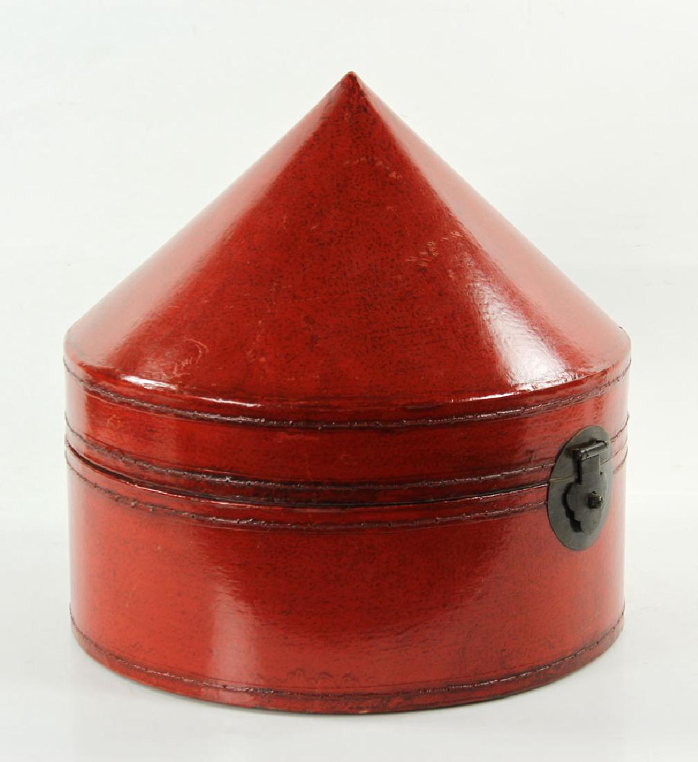 Chinese Wood and Red Leather Hat Box: Chinese wood and red leather hat box, with conical top, from Hebei Province, 15" h x 14 1/2" dia. Provenance: From the personal collection of Cheryl Burke, of Sarasota, Florida.