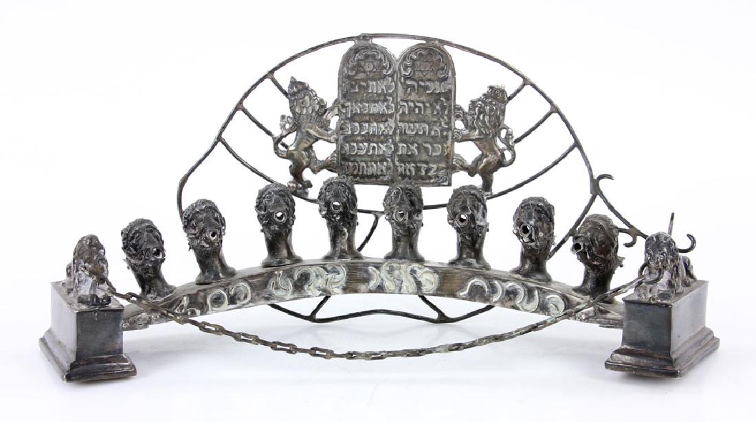 Silver Menorah: Menorah, silver, decorated with lion's head and breast plate, marked .925, 5" h x 10" w. Provenance: From a California collection.