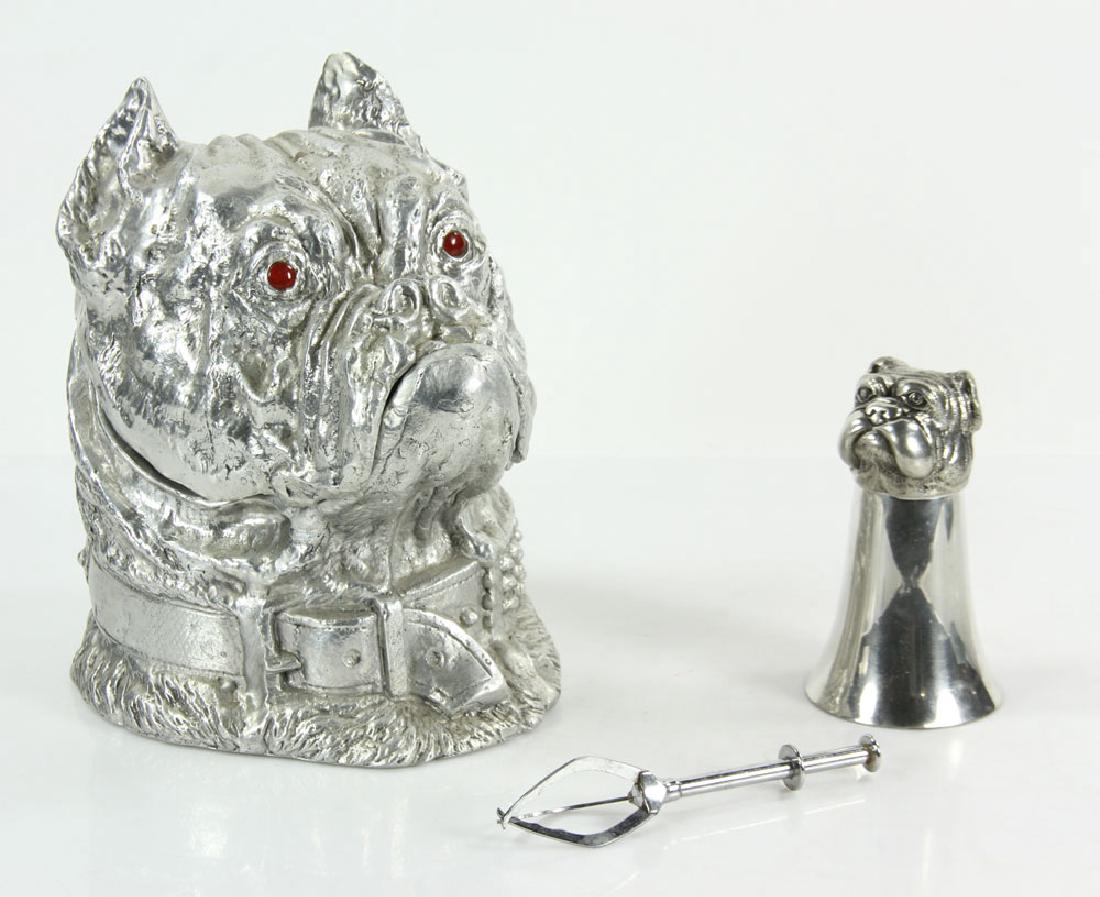 Bull Dog Ice Bucket and Shot Glass: Bull dog form ice bucket, with bull dog form shot glass and pair of ice pincers, bucket 10" h x 6 1/2" w x 8 "d, shot glass 5 1/4" h, pincers 5 3/4" l. Provenance: From the lifetime collection of Cher