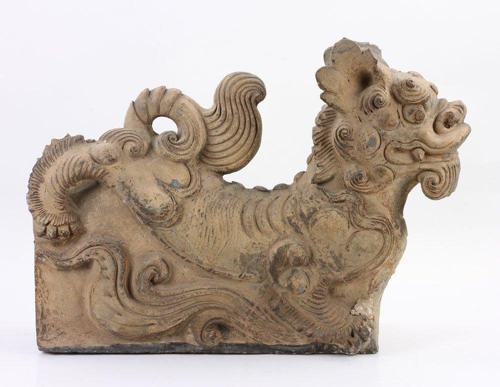 Chinese Stone Foo Dog Roof Tile: Chinese Ming Dynasty foo dog form roof tile, carved stone, circa 1600, 16 1/2" h x 21 3/4" w x 6 3/4" d. Provenance: From the lifetime collection of Cheryl Burke of Sarasota, Florida.