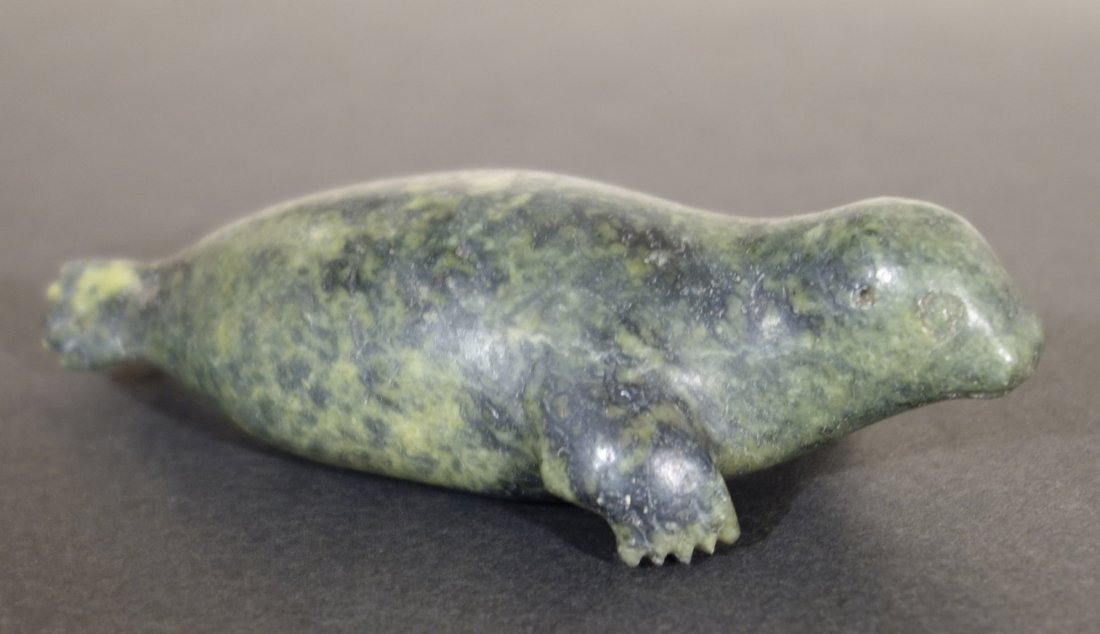 Josie AMITOOK - Seal: Josie AMITOOK (Eskimo, 20th century) Seal. Green soapstone. Signed on stomach. Sealed. Ca. 5 x 2 x 2 inches.
