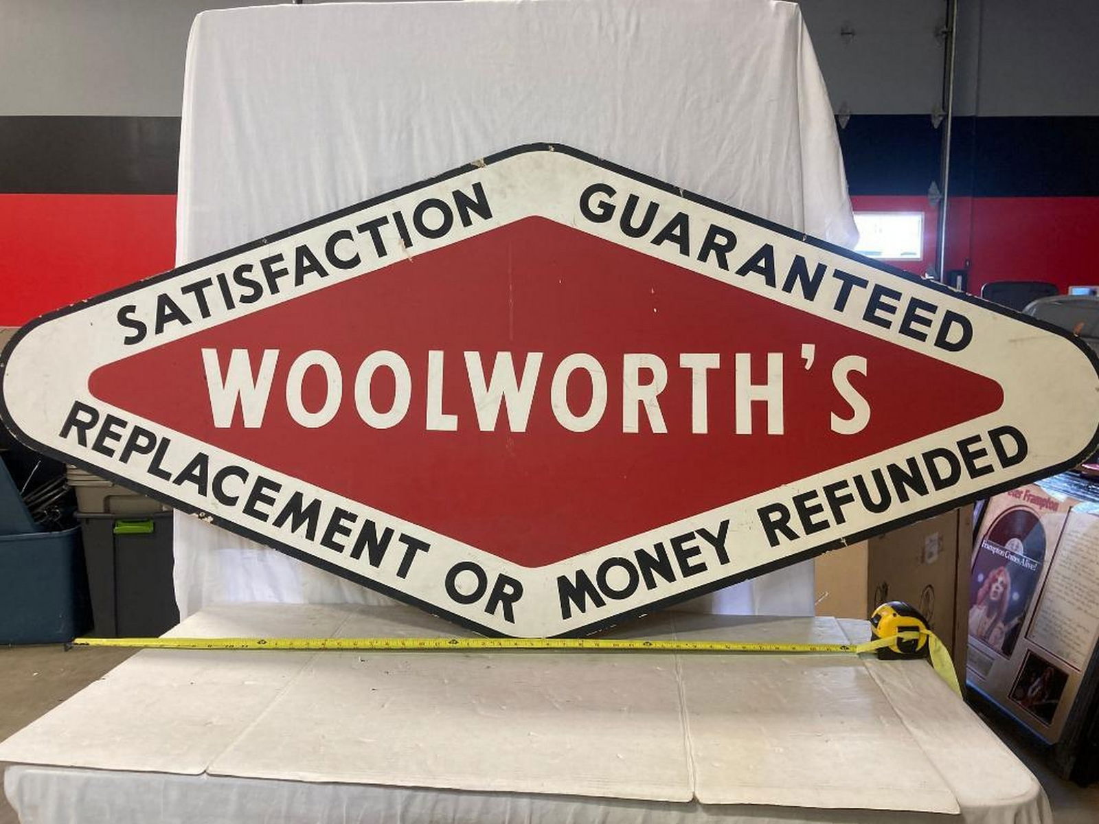 1920's "Woolworth's Satisfaction Guaranteed" Advertising Sign: Pressed fiber sign. Measures 72x33, singled sided.
