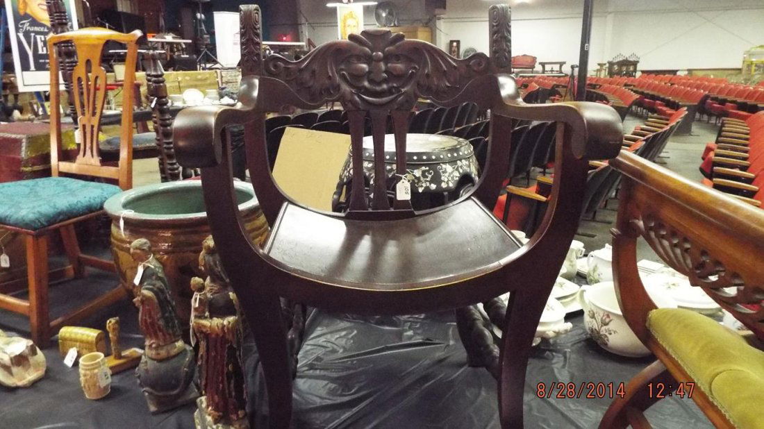 Two chairs, mahogany arm chair with the "old man of the: Two chairs, mahogany arm chair with the "old man of the north wind" carved back 34 1/2"H 23 3/4"W 22 1/2"D seat is 16"H and an unusual bench with tufted seat 24 1/2"H 24 3/4"W 18 3/4"D seat is 12"H no