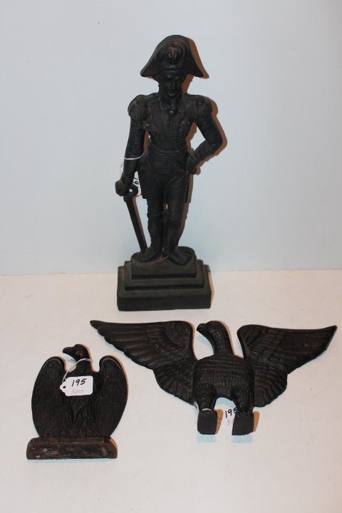 Three pieces of cast iron, two doorstops French soldier: Three pieces of cast iron, two doorstops French soldier 16"H & and eagle 6 1/2"H, eagle wall hanging 7"H 15" wingspan no ref.#