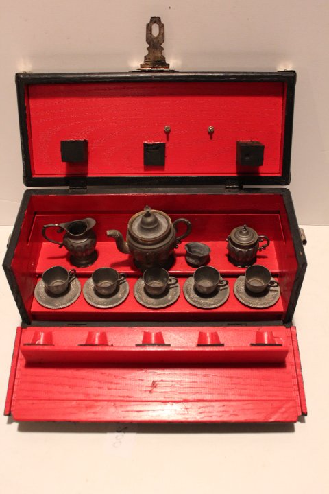 Fourteen piece miniature pewter tea set in original: Fourteen piece miniature pewter tea set in original presentation wooden box mkd. Pewter 1970 five cups & saucers, teapot, cream, sugar & waste bowl, box is 5 1/2"H 11 1/4"L 4 1/2"W no ref.#