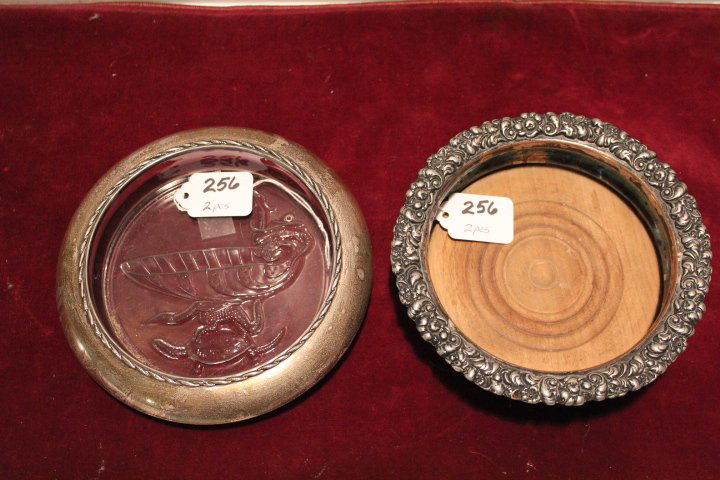 Two wine bottle coasters, silver plate with wooden: Two wine bottle coasters, silver plate with wooden bottom 2"H 6 1/4"D & one with an embossed glass bottom & a sterling silver band 1 1/4"H 6 3/4"D no ref.#