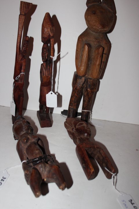 Five pieces, African carved rabbit man 13 1/2"H, two: Five pieces, African carved rabbit man 13 1/2"H, two wooden carved African figures 11 3/4"H & 11"H, carved Afrivan woman legs missing 9 1/2"H & a wooden carved African two faced? Possibly a handle 7 1