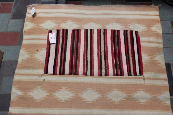 Two native American items, saddle blanket 18" x 34: Two native American items, saddle blanket 18" x 34 1/2" & a rug 54" x 86" stains, in the picture rug is folded in half no ref. #