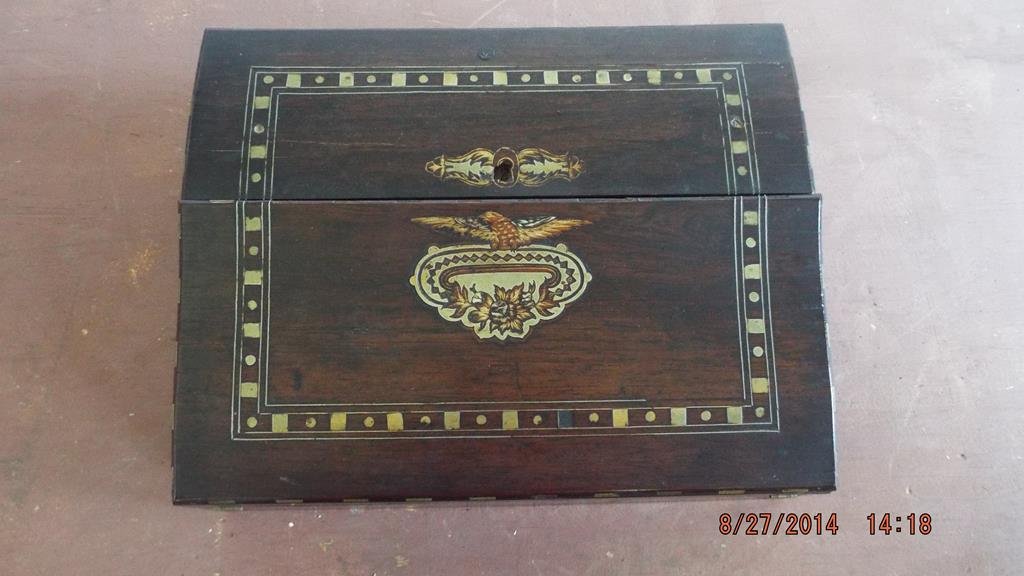 Early rosewood lap desk with simple brass inlay and: Early rosewood lap desk with simple brass inlay and painted decoration, minor veneer damage and inlay loss, two sections unfold to expose felt writing surface with storage beneath and supply storage a
