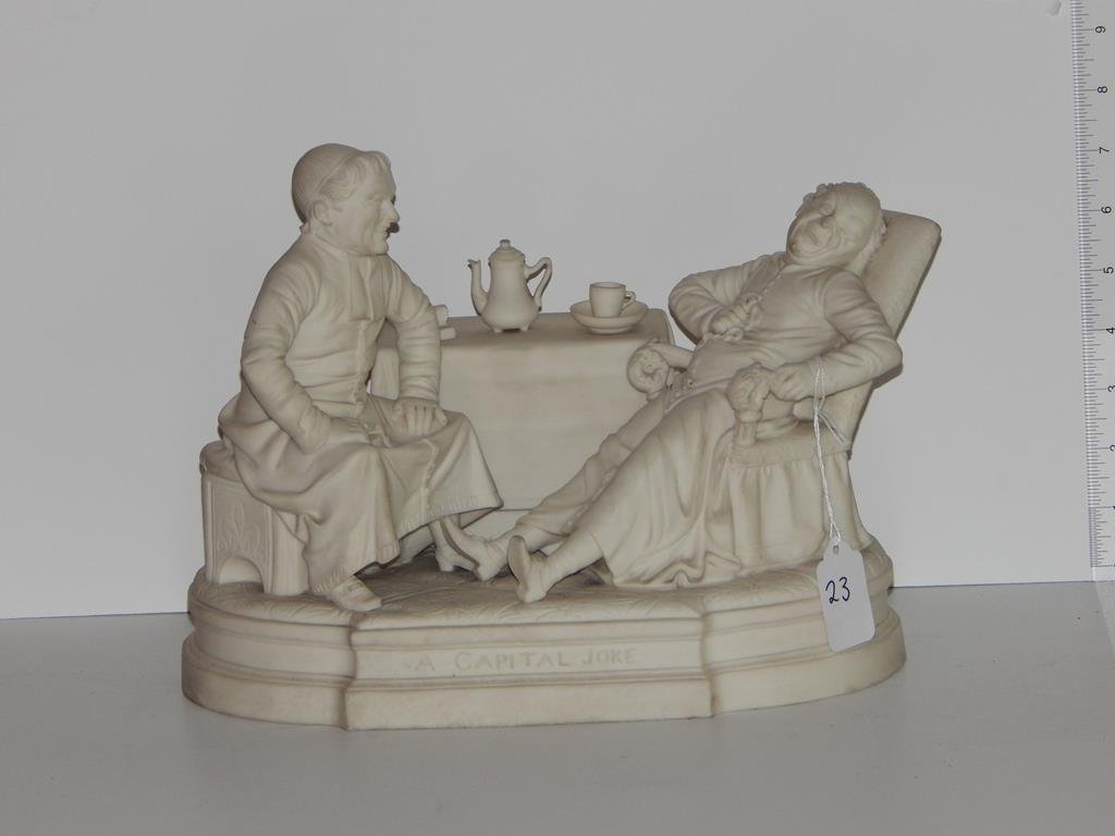 Bisque figure grouping, titled "a capital joke" 8 3/4"H: Bisque figure grouping, titled "a capital joke" 8 3/4"H base is 6 3/4" x 11 1/2" teapot has been glued to the table, ref.#23