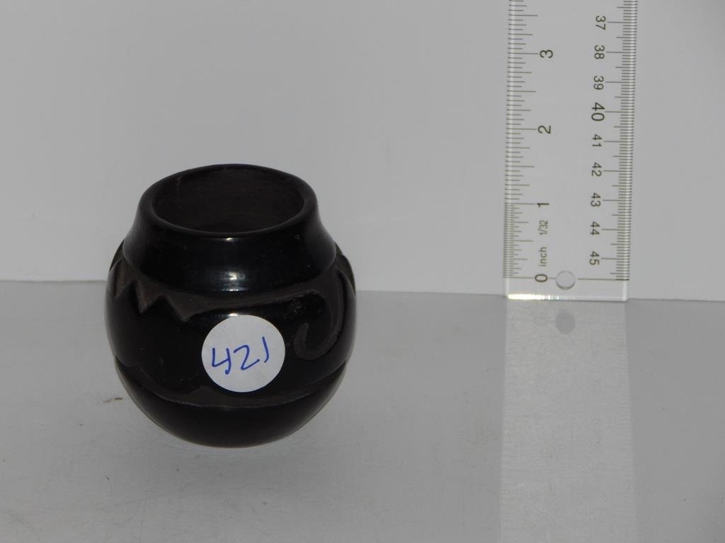 Three pieces of Native American black ware pottery, 4: Three pieces of Native American black ware pottery, 4 3/4"H Santa Clara vase, decorated bowl 3 1/2"H and a small vase signed Teresita 3"H imperfection to the rim in the making ref.#421,553,802