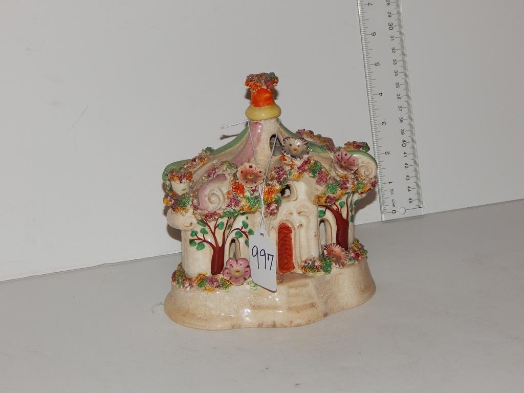 Two pieces of Staffordshire toby jug 10 1/4"H minor: Two pieces of Staffordshire toby jug 10 1/4"H minor flakes and a cottage with applied flowers 6 3/4"H ref.#997,1266