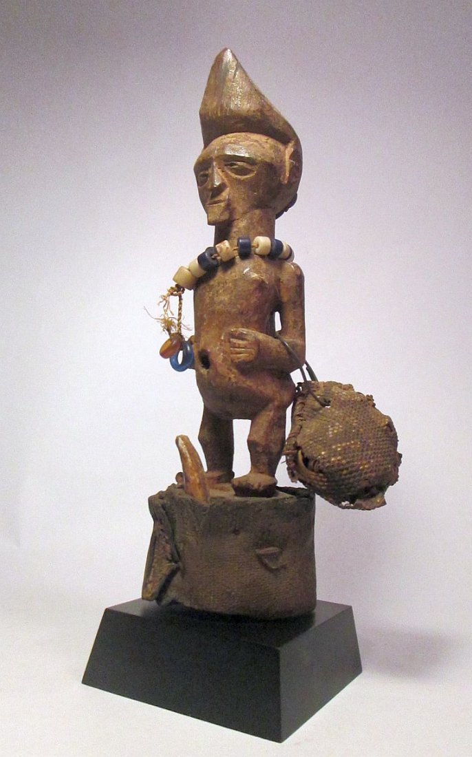Rare Old Tetela Magic fetish figure from Congo, Africa: a Very rare TETELA MAGIC FIGURE, DRC / CONGO. Ritual statue with attached magic regalia, including bone, animal skin, and glass beads, early to mid-20th c. Mounted on painted wood base. 10'' x 3 1/2''