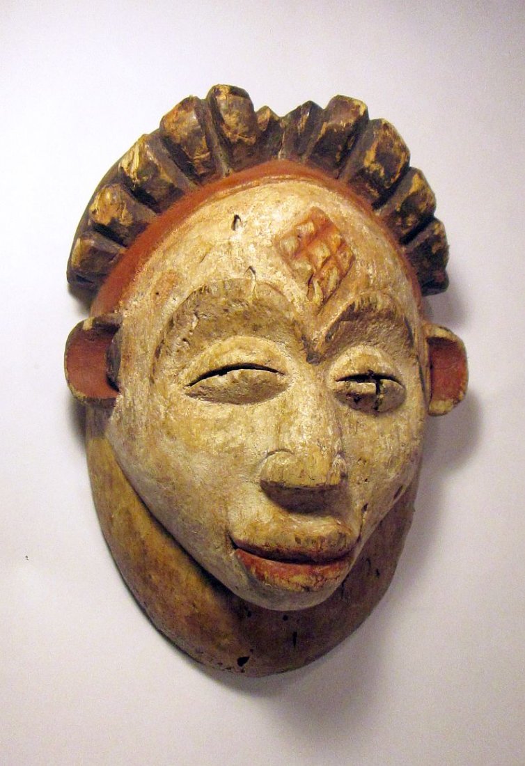 Punu African mask: Very old carved wooden mask from the Punu tribe of Gabon, west Africa. Such masks were known as "maidens spirits" and were worn by stilt walkers during ceremonial dances.This mask shows great age , ad