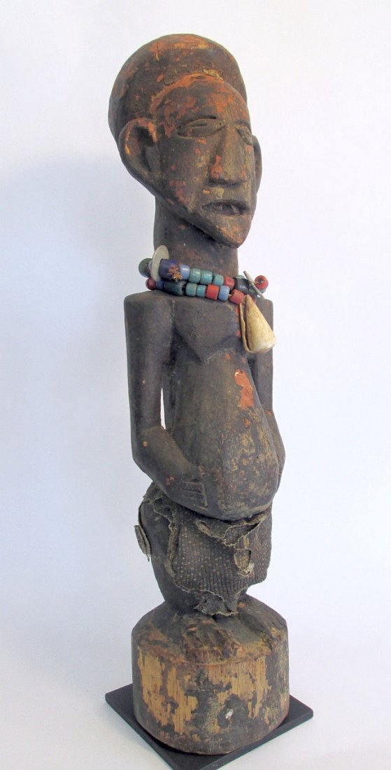 Songye N'kisi Magic Fetish, African Art: This is an old wood sculpture from the Songye peoples of the Congo, Central Africa. Magic fetish object with heavy encrusted patina and signs of weathering and age, the sculpture is adorned with beads