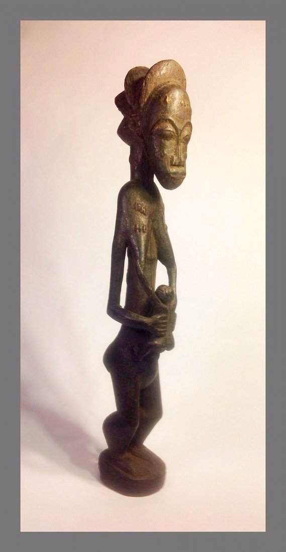 Baule Maternity sculpture Mother & Child, African Art: Older carved wooden Maternity sculpture from the Baule peoples of West Africa. Serene image of a mother with child at her breast, with elongated and exaggerated style.The figure is older and has some 
