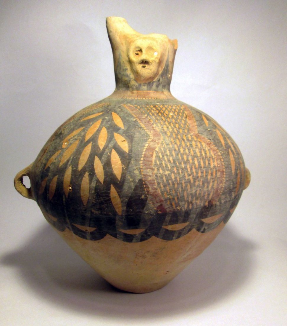 Huge Chinese Neolithic pottery vessel with human face: Large ancient ceramic jar vessel, with richly painted symbols and motifs, unusual style with dual spouts and anthropomorphic face, otherwise a classic form with lug handles. 15 inches tall x 12 1/2 in