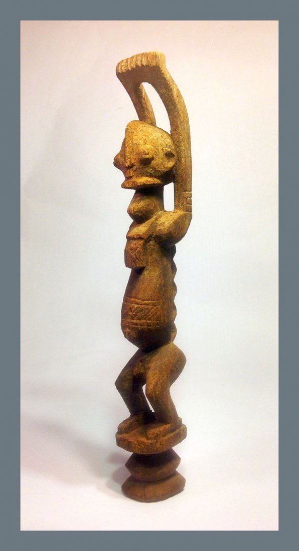 Dogon Nommo Ancestor idol w/ raised arms in prayer: Carved wooden idol from the Dogon culture of Mali, Africa of Nommo , shown in Prayer with arms raised to the heavens. Old carving with obvious age and wear. Measures 16 inches tall and has a 2 lb ship