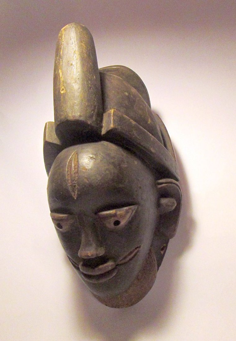 Yoruba Dance mask from Nigeria, African Art: Carved wooden mask from the Yoruba tribe of Nigeria, Africa. mask has wonderful headdress and facial scars, downward cast eyes. The mask measures 13 x 7 inches. buyer to pay for a 4 lb package.