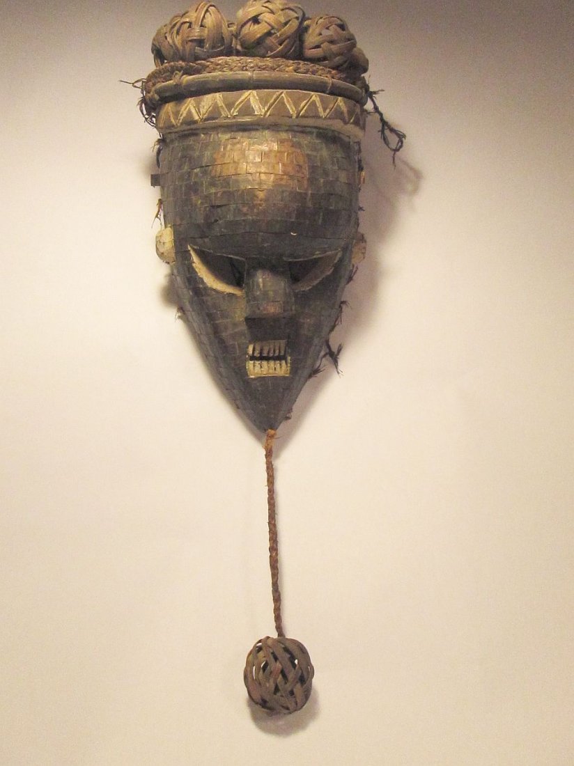 Salamapasu African Tribal mask with Copper adornment: Carved wooden mask from the Salamapasu culture, Congo, Africa. This mask has attached rattan basketry and hand hammered copper covering the mask face. 12 x 8 inches. buyer pays for a 3 lb package. Ex-