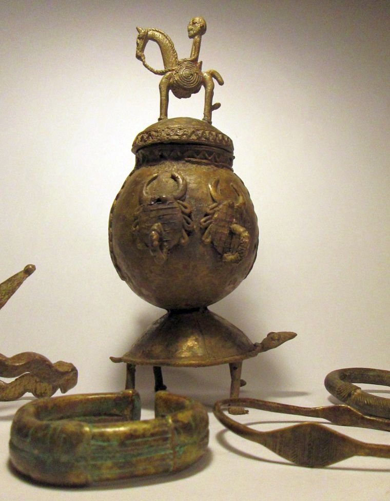 Collection of West African bronze artifacts African Art: Group of 5 West African bronzes including a Dogon Tobbaco container with Horse and rider on lid, a gan two headed serpent armband, a Senufo anklet, a Ashanti/Akan anklet and a bronze bracelet / curren