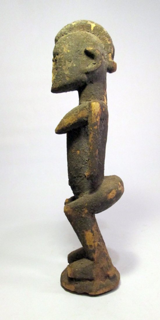 Very Old Dogon female sculpture from Mali, Africa: Description: carved wooden female shrine idol with heavily encrusted surface, suggesting ritual use over many years. The surface of this idol is great evidence of its use, the idols lower feet and leg