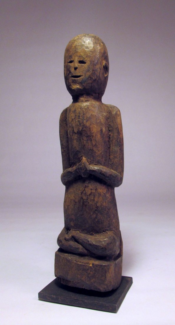 Serene Praying Nepal Wood idol, Magar Tribe, Middle Hi: Serene Old Praying Shrine idol from NepalThis is a charming old carved wood idol from Nepal. Shown with hands in prayer and sitting cross legged. What a beautiful example of the Tribal Buddhist tradit