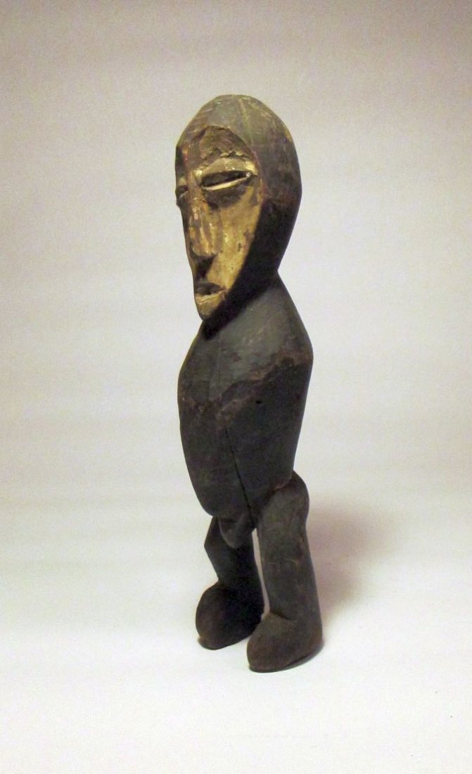 Old Lega male idol, African Art: Carved wooden shrine figure from the lega of the Congo, Africa. kaolin painted face and unusual carved body with no arms. Measures 11 inches tall. Ex- Steve Tobin Collection.