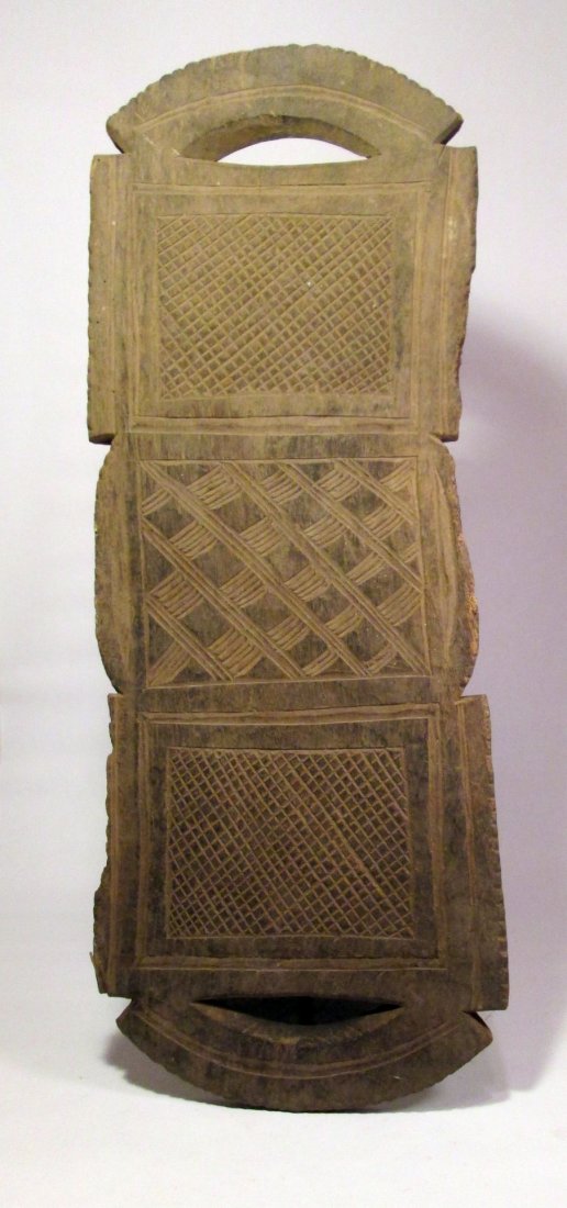 Old Carved wooden tray from the NUPE of Nigeria: This is a very old carved wooden tray from Nigeria and the Nupe peoples. a large wooden panel with incised designs and two handles, all carved from a single piece of wood. The tray has obvious age and