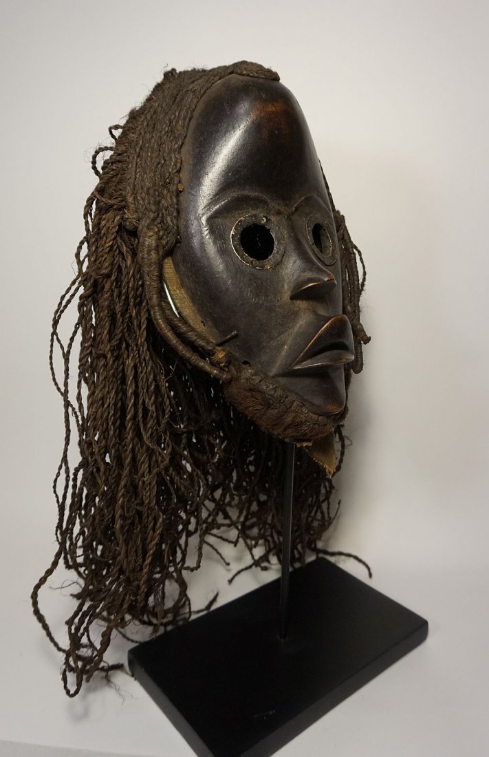 Dan Poro Secret Society mask, African Art: Carved wooden mask with metal accents around the large open eyes, as well as an elaborate woven grass rope coiffure / wig, attached to the back of mask. A Very high quality example with fine craftsman