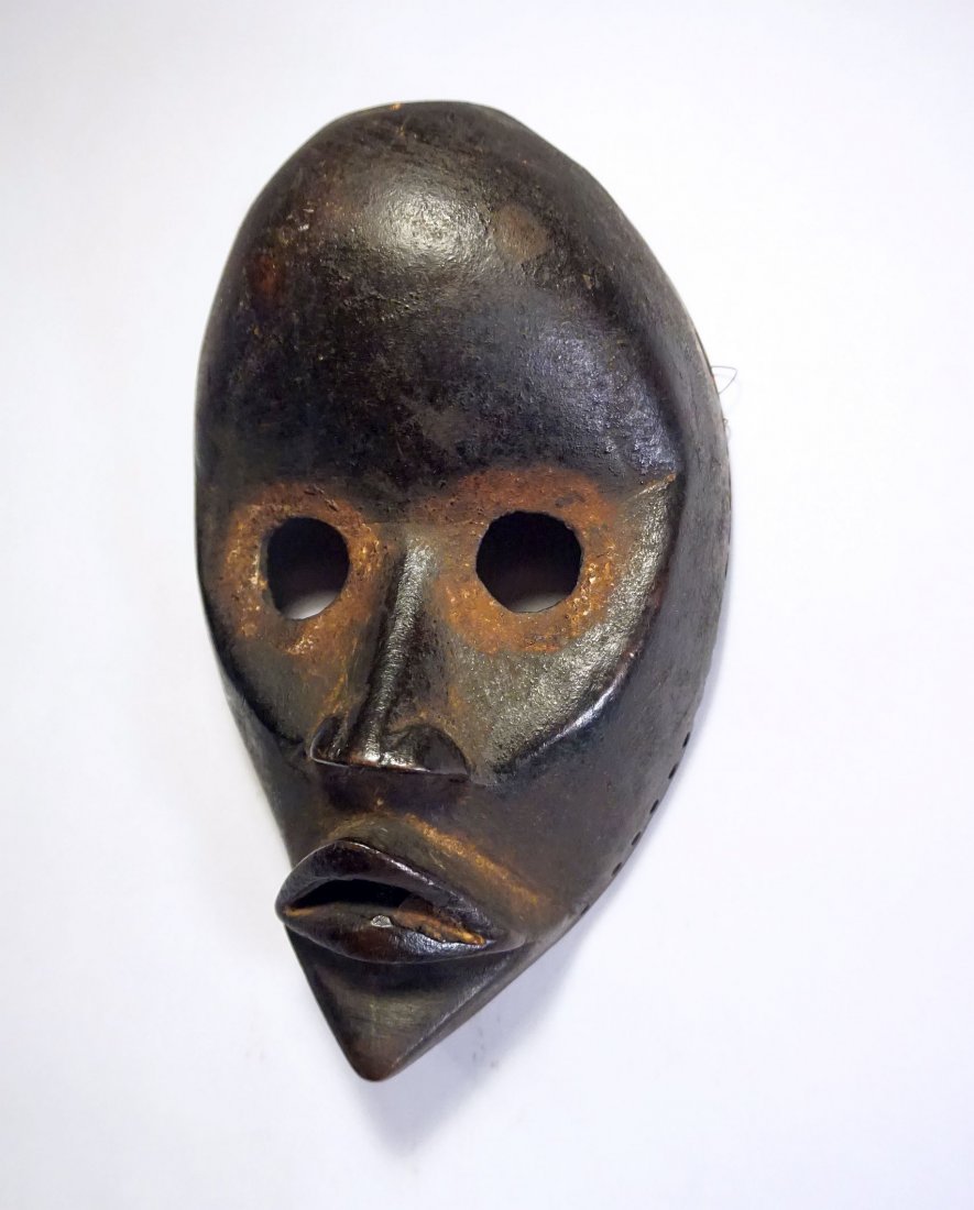 Classic Old Dan African mask, African Tribal Art: Carved wooden mask from the DAN peoples of Cote d'ivoire , West Africa. Realistic wooden face mask with carved facial features,large open eyes and pursed lips. Large domed forehead , Nice older exampl