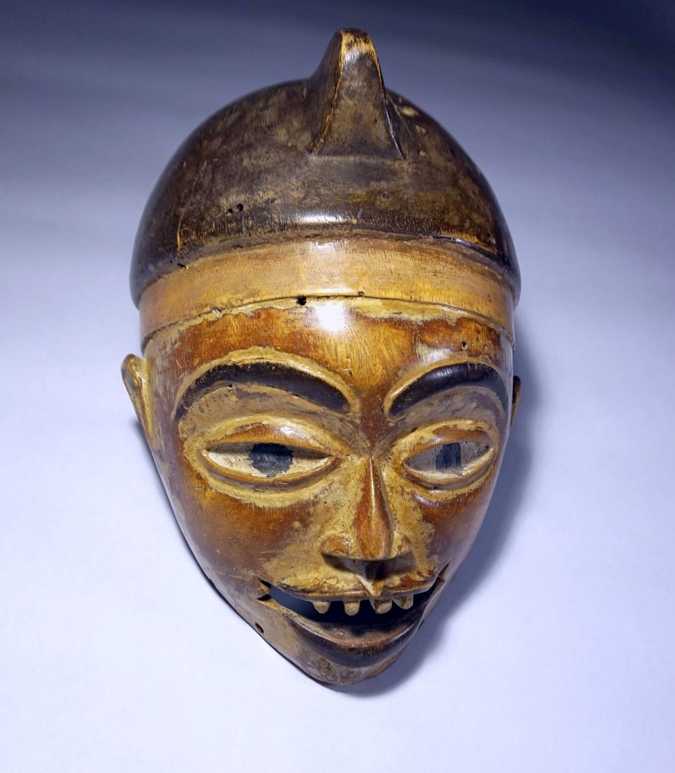 KONGO / YOMBE African mask: Carved wooden mask from the Kongo or Yombe peoples of the Congo, central Africa. Realistic wooden face mask with carved facial features such as ears, large eyes and filed teeth. kaolin clay accents. L