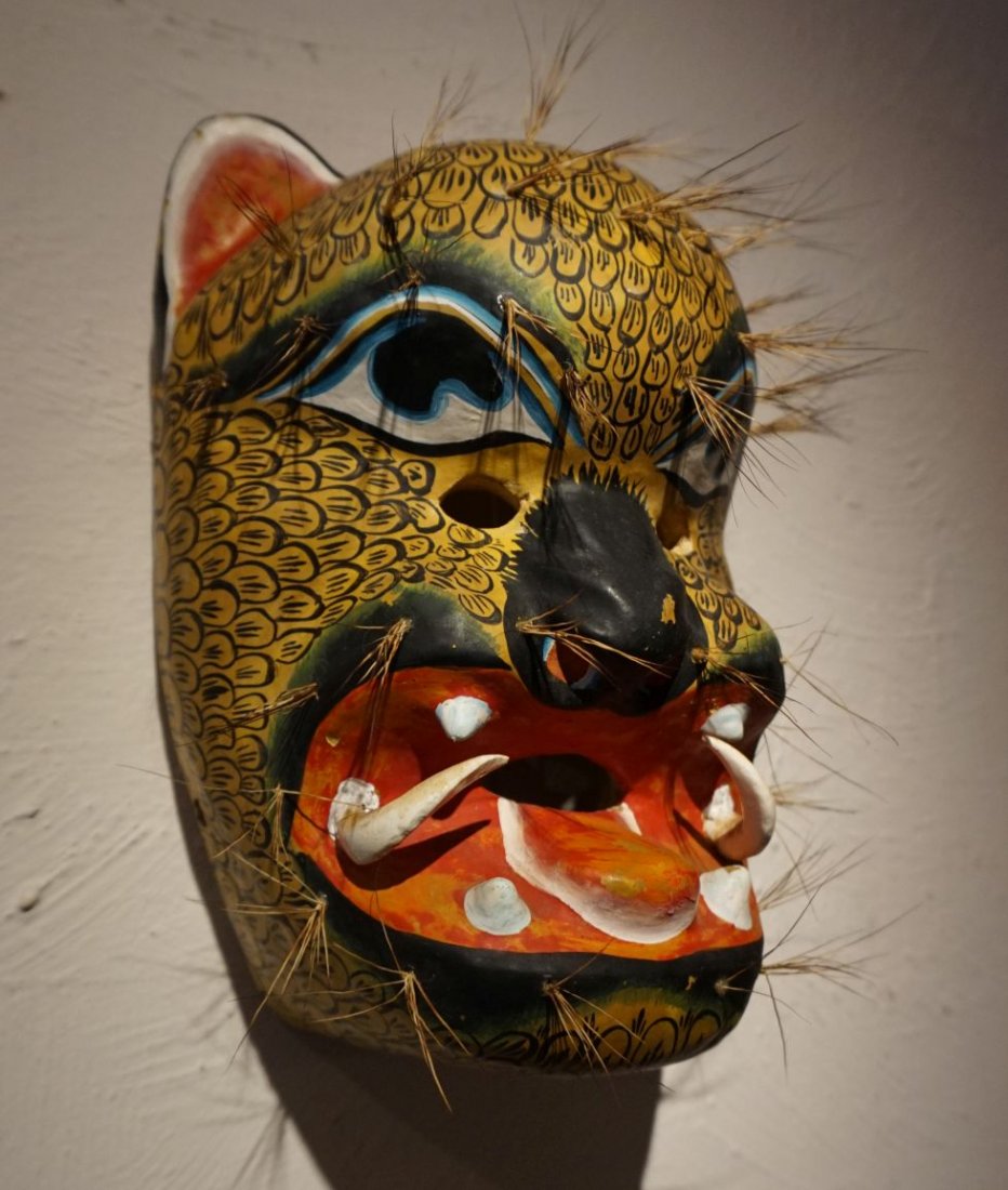 Mexican Tiger mask , Jaguar , native mask: Carved wooden Tiger or Jaguar mask from Mexico. Elaborate painted designs and accented with many tufts of hair. Measures 10 x 7 inches.
