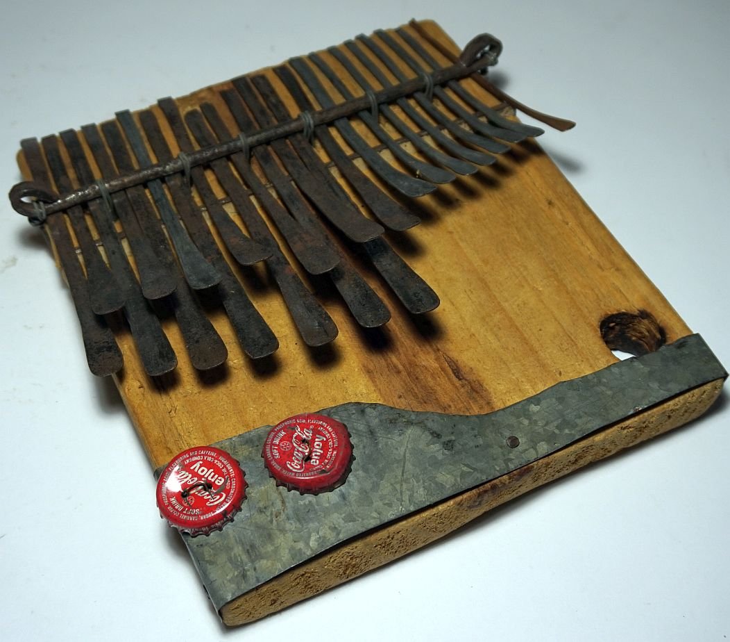Large old Kalimba , Thumb Piano , East African Musical: This is a large hand made East African Thumb Piano or Kalimba, Musical instrument. This carved wooden box with attached metal keys and even some bottle caps for rattle effects. The Kalimba has a wonde