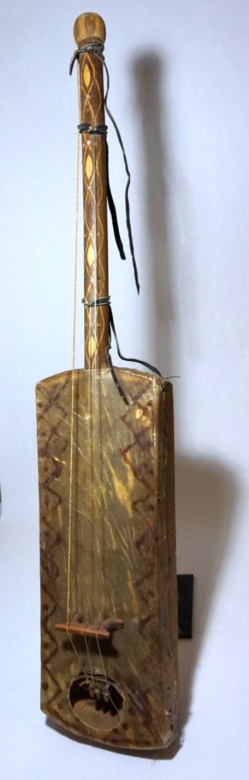 Rare Gambara Slave Instrument from Tunesia: This is a very uncommon style of string Instrument from Nth and west Africa. Carved wood with animal hide and a tall central neck. This instrumet is typically only used by descendants of the sub-Sahar