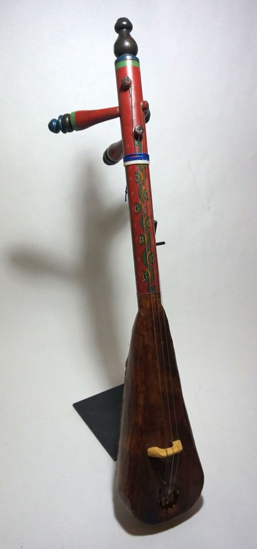 Beautiful Vintage Gunbri North African Painted Lute: Carved wooden Lute with ornate painted design on the reverse. The gunbri is found North of the Sahara, played mainly by the Berbers and Rwais tribes in Morocco. The body is a rounded piece of wood hol