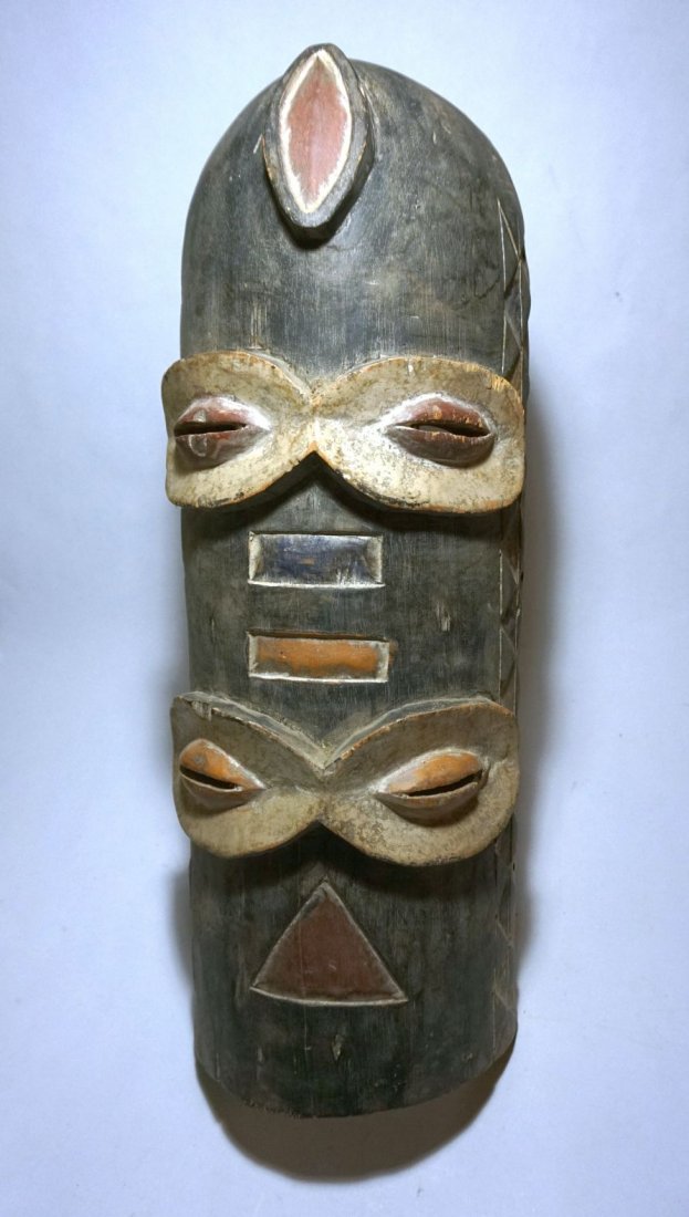 Tall Abstract Bembe African Mask, African Art: Carved wooden mask with multiple eyes and tribal motifs. From the Bembe peoples, Congo, central Africa. Measures 24 x 8 inches.