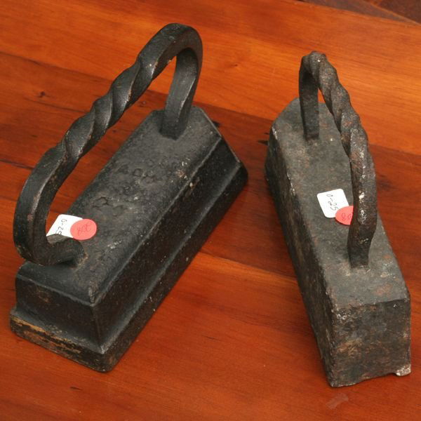Two cast iron irons, 9 3/4" x 3 1/2", 7" tall, 9: Two cast iron irons, 9 3/4" x 3 1/2", 7" tall, 9 3/4" x 2 1/4", 7 1/2" tall. Good old condition.