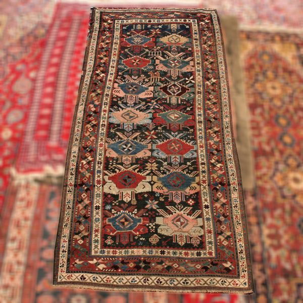 Russian Kuba antique wool rug, 1880's, 3'7" x 8'5": Russian Kuba antique wool rug, 1880's, 3'7" x 8'5", overall geometric rosettes, multiple borders, varied colors. Overall good condition.