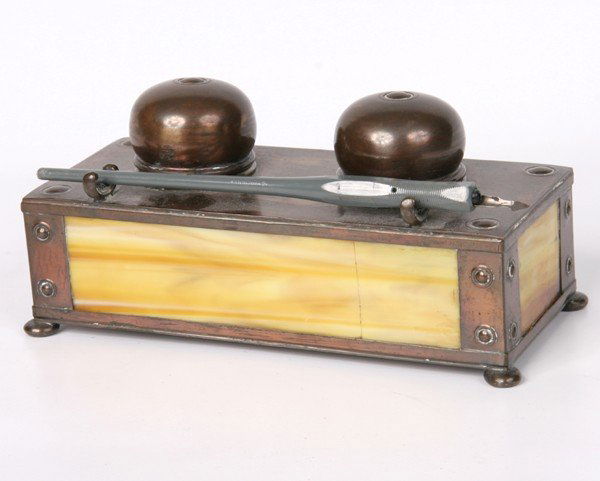 Early 1900 arts and crafts inkwell, "Apollo Studio: Early 1900 arts and crafts inkwell, "Apollo Studios New York", brass, yellow slag glass panels, two original glass inkwell inserts, 7 1/2" x 3 1/2", 3 1/2"t. Two cracked glass panels.